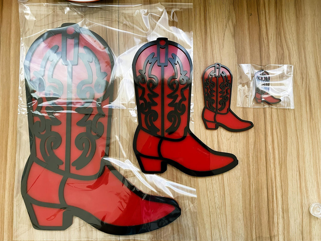 Red cowboy boot-shaped items on a wooden surface