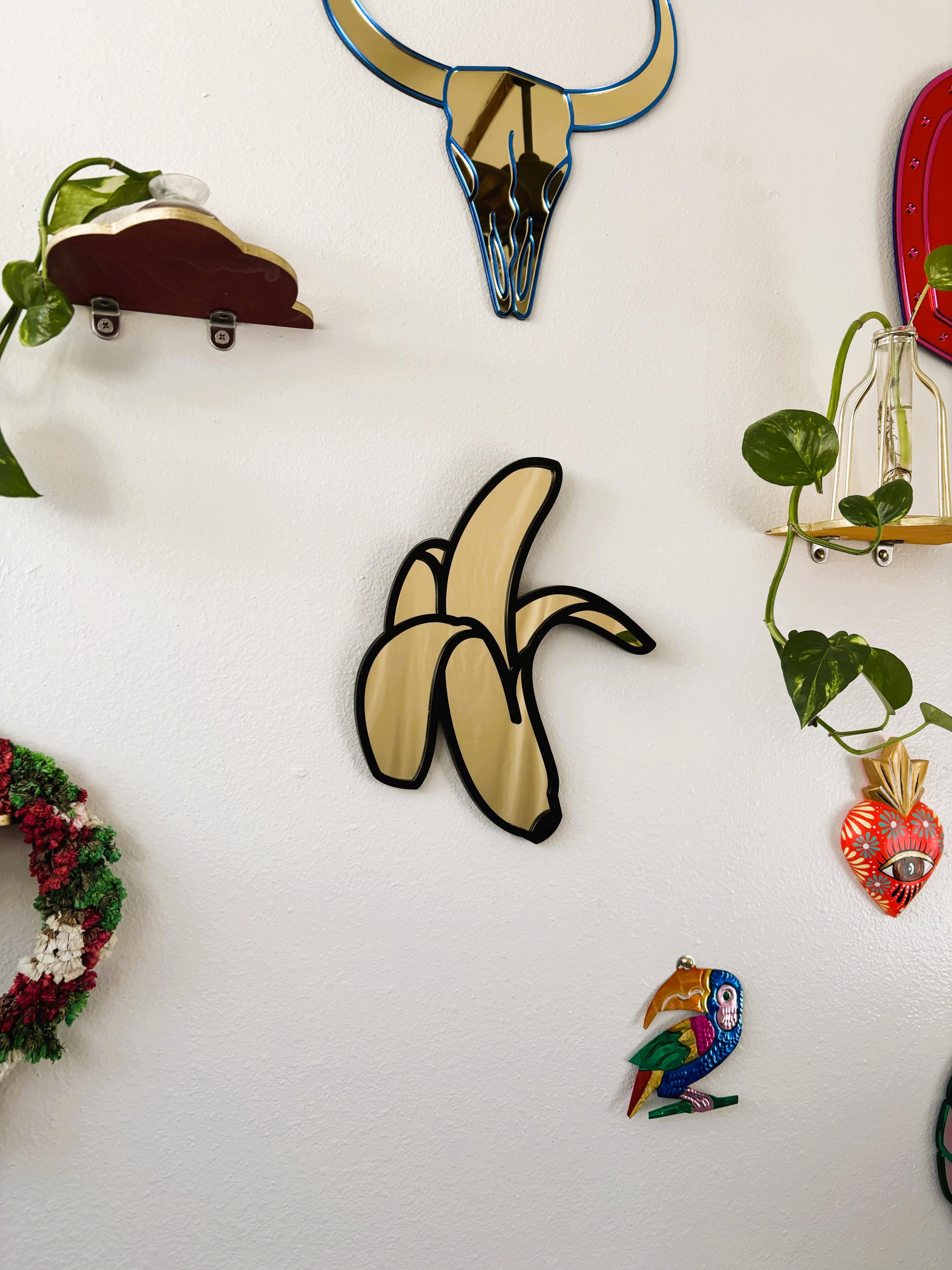 Collection of decorative wall art pieces on a white wall.