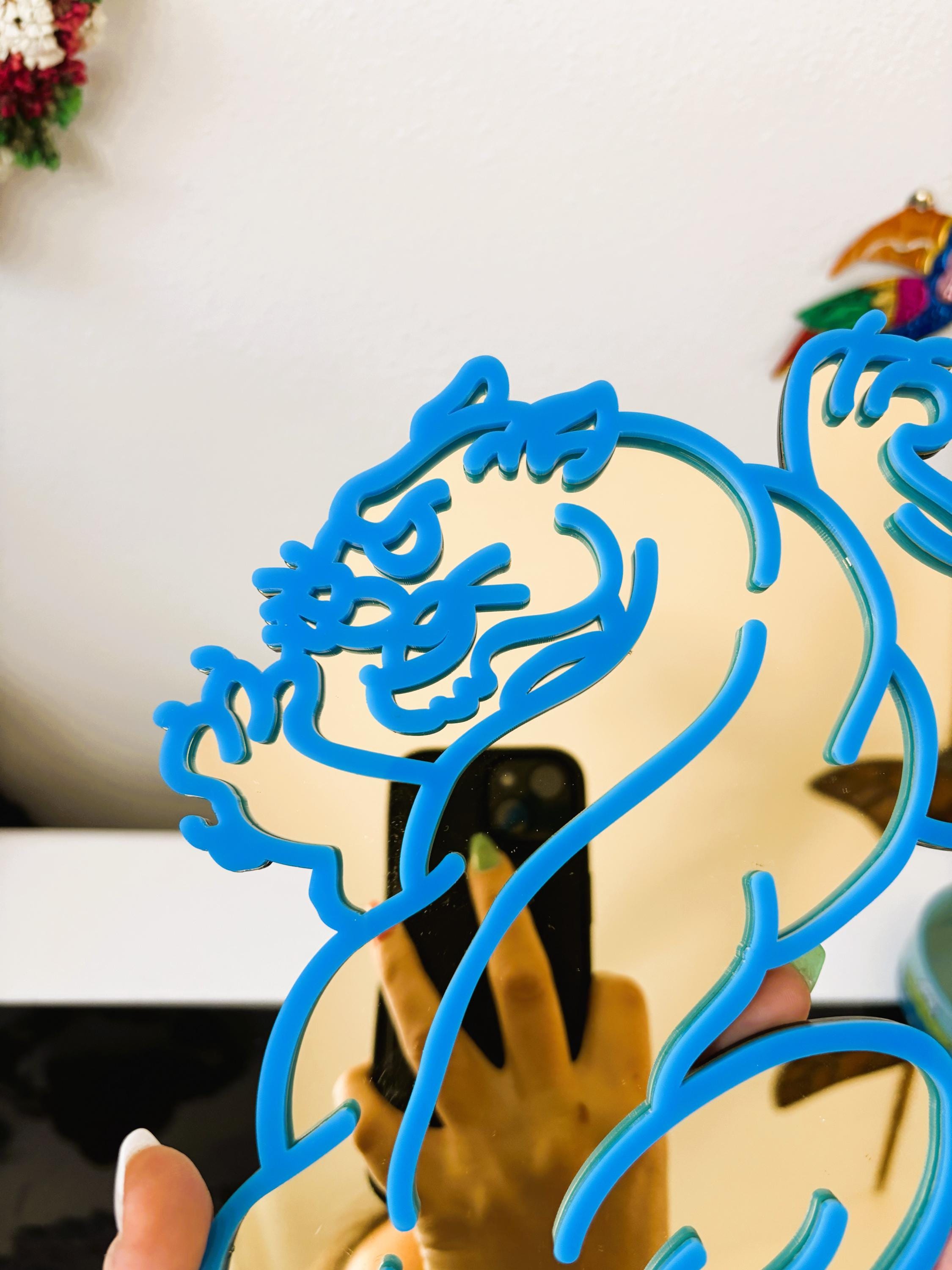 Decorative item with blue dragon design on a white background