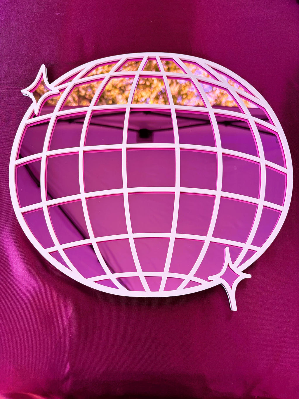 Decorative wall art with a globe design on a purple background
