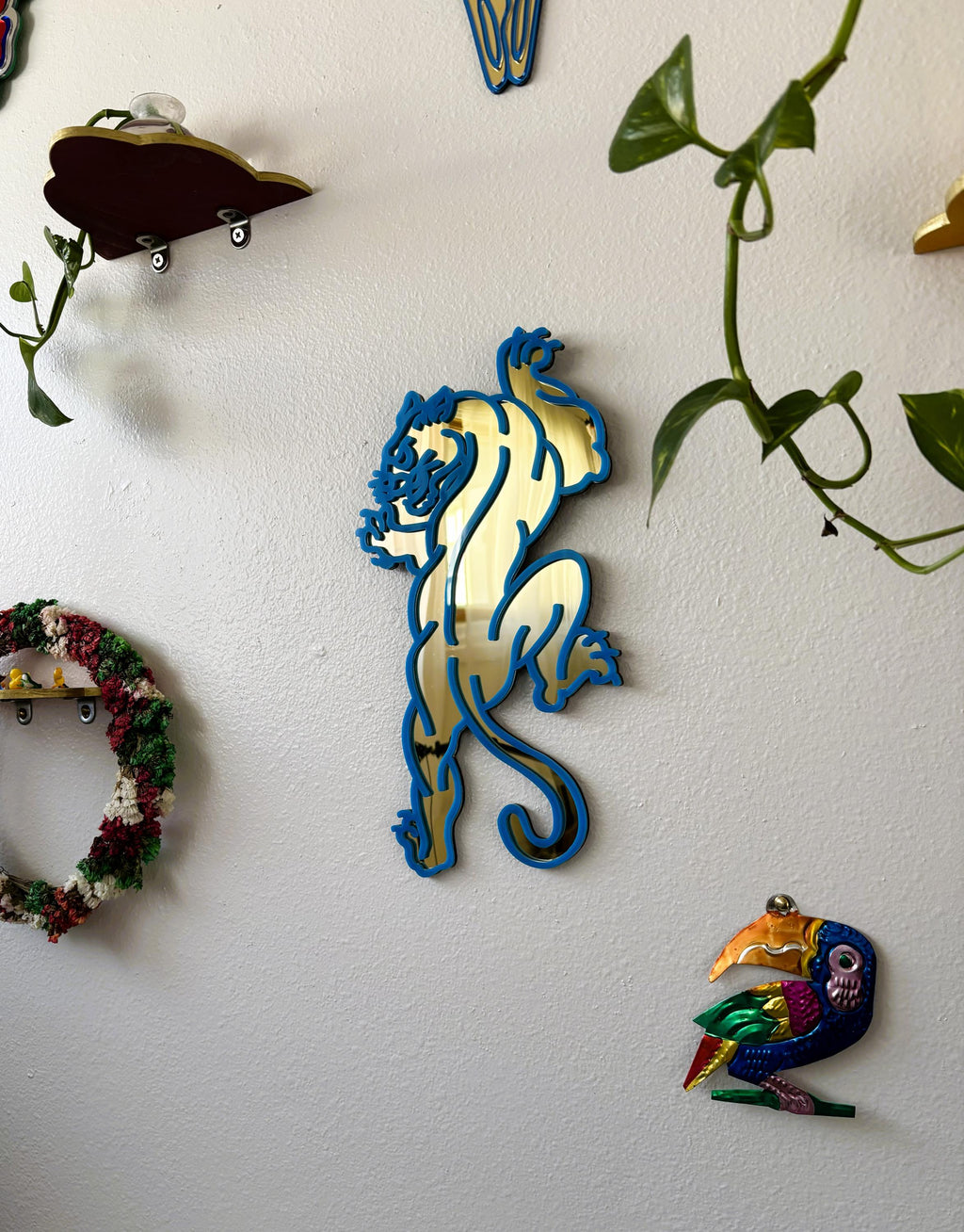 Decorative wall art with a lion design on a white wall.