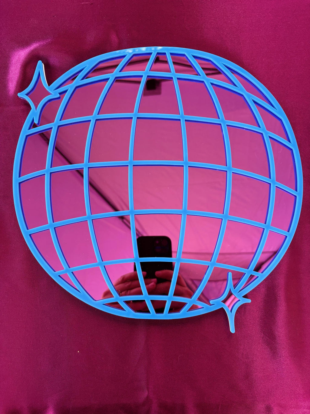 Blue wire globe design on a pink background