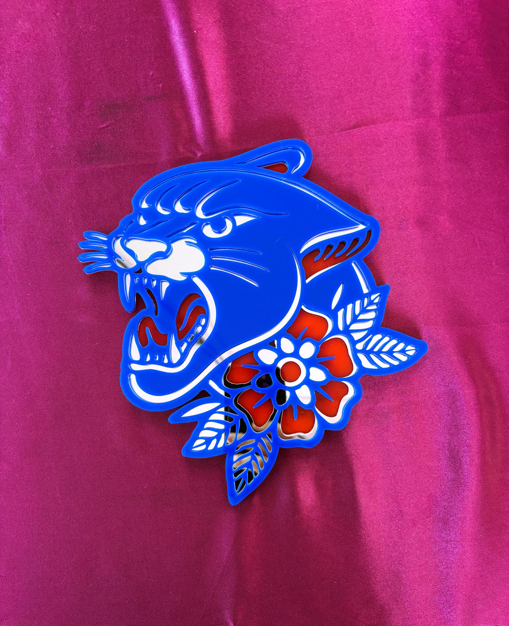 Blue panther design with flowers on a pink background