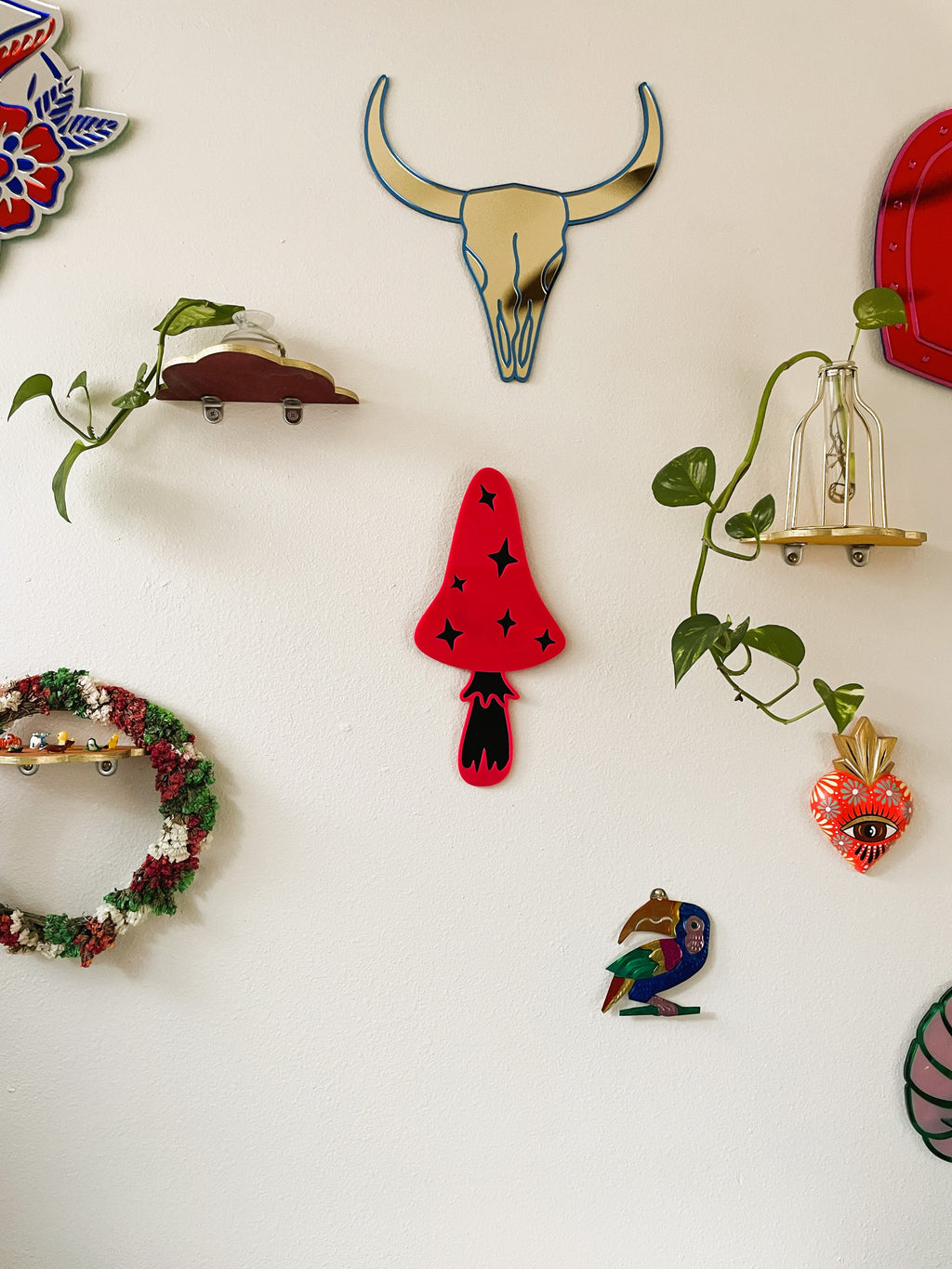 Collection of decorative wall art pieces on a white wall