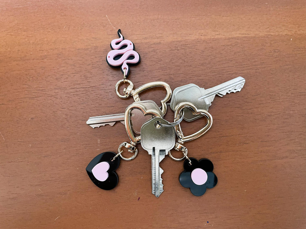 Keychain with keys and charms on a wooden surface