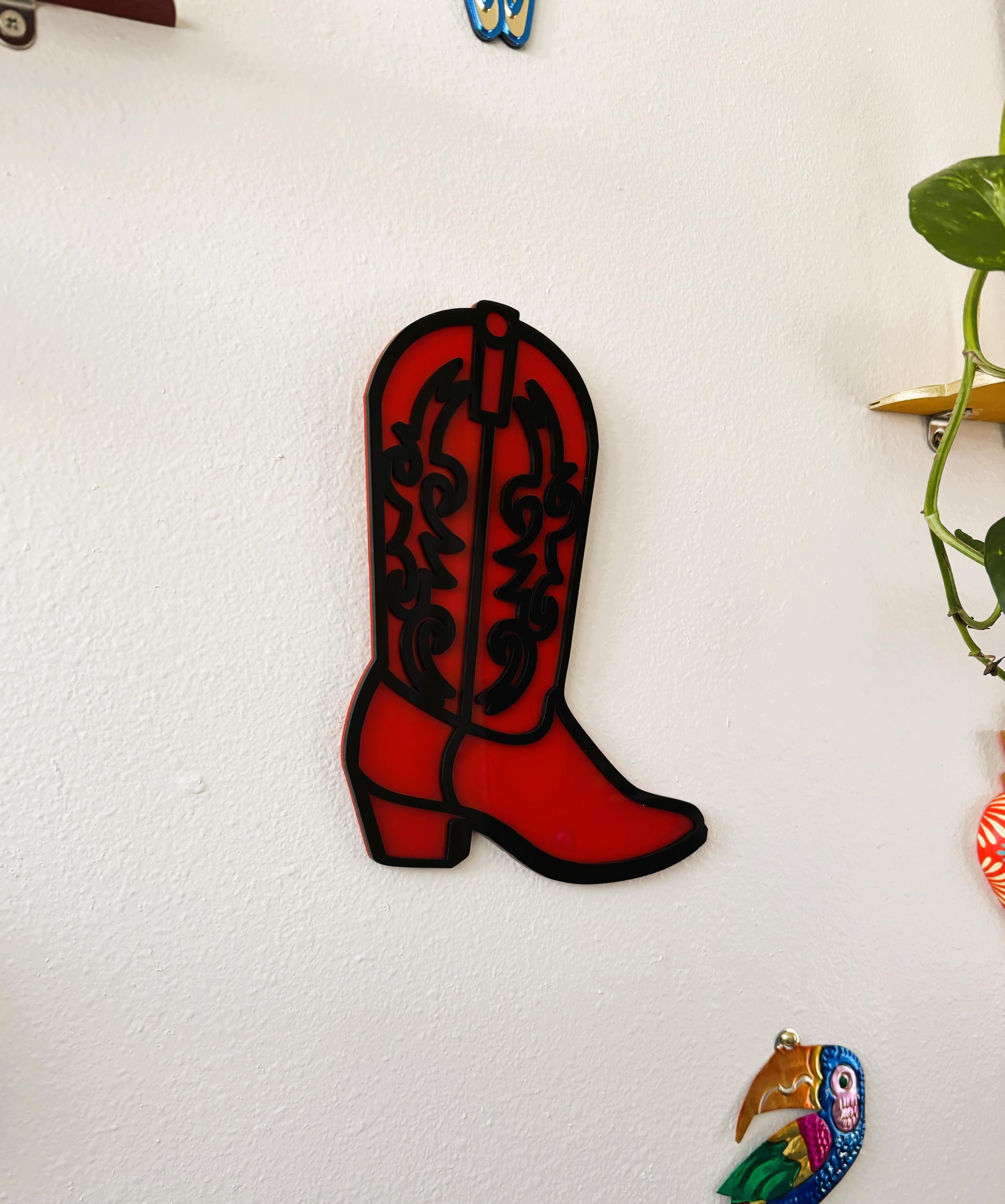 Red cowboy boot-shaped object on a white background