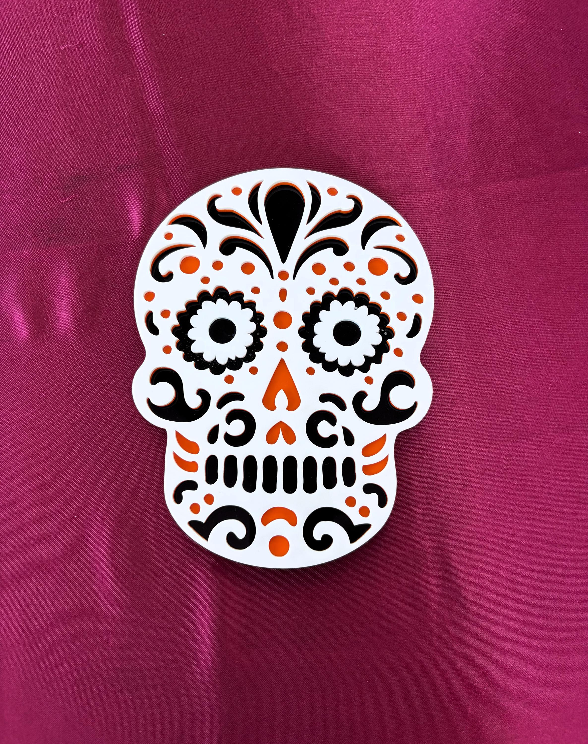 Decorative skull design on a pink background